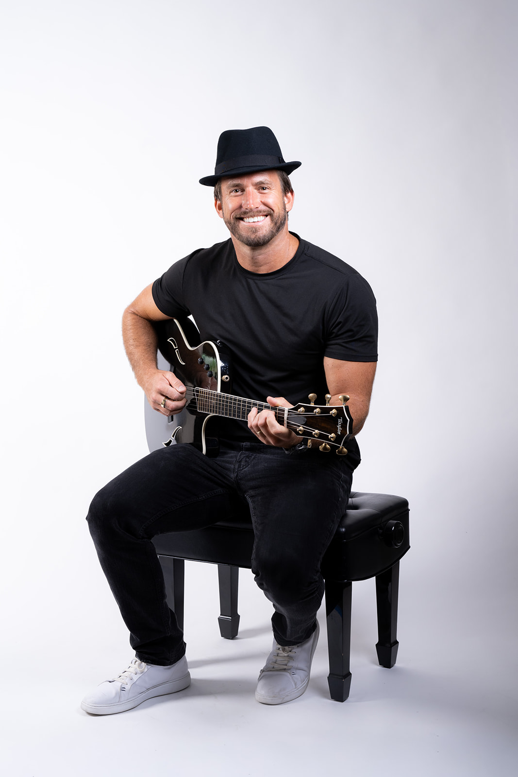 Ryan Hiller seated with guitar