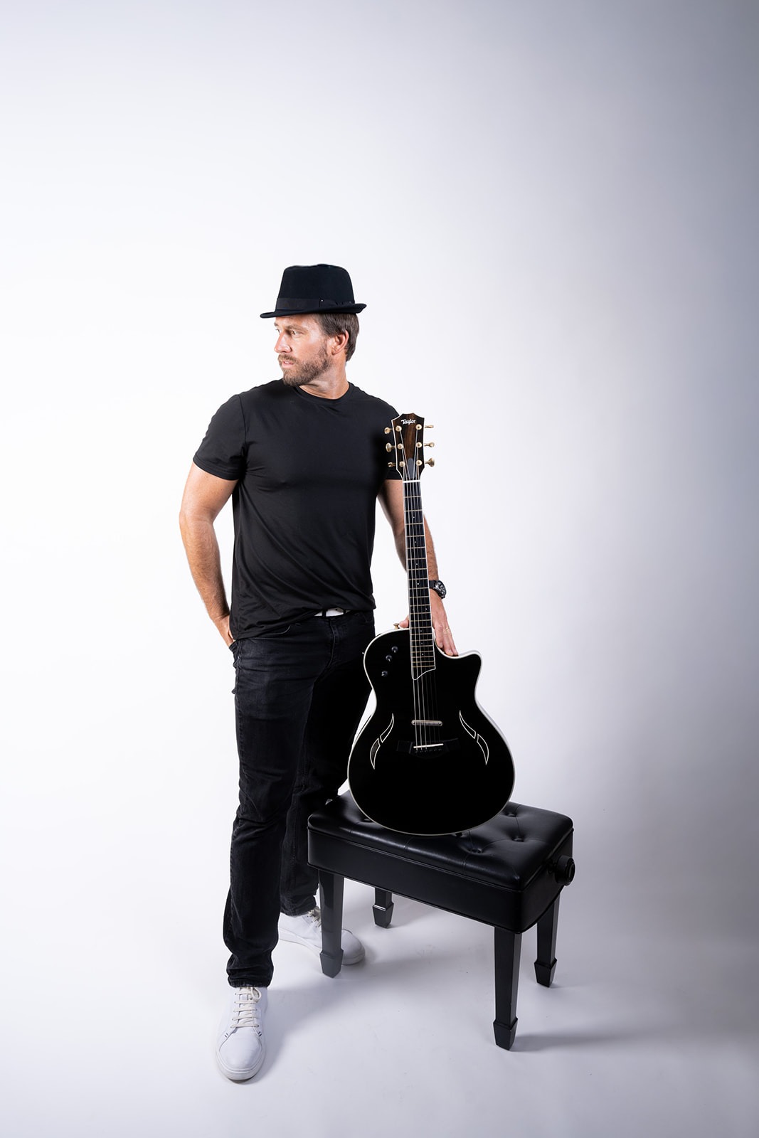 Ryan Hiller standing with guitar